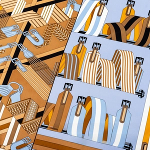 Detailed pattern of silk scarf featuring equestrian belt prints and diagonal stripes