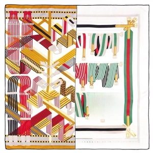 Macro detail of silk square scarf featuring equestrian belt prints and hand-rolled edges