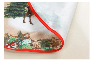 Close-up of Christmas tree skirt with festive reindeer and gingerbread prints