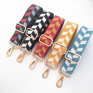 Adjustable wide woven shoulder straps with arrow pattern and gold metal buckles for handbags