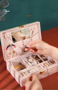 Detailed interior of a pink PU leather jewelry box showing double-layer storage compartments