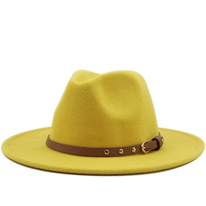 Detailed view of yellow wool felt fedora hat featuring a brown leather band with metal studs