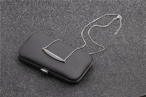 Macro shot of micro-pave zircon bar necklace pendant on a textured black gift box