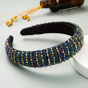 Macro shot of handcrafted baroque headband with multi-color beads and black velvet lining