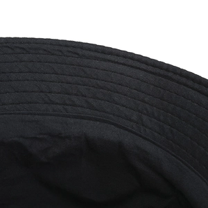 Detailed close-up of the black bucket hat brim with reinforced multi-row stitching