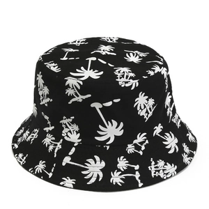 Close-up detail of black sun hat with all-over white coconut tree print patterns
