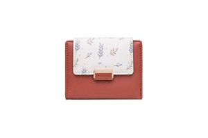 Close-up of red-brown and white PU leather short wallet with printed floral pattern and metal buckle