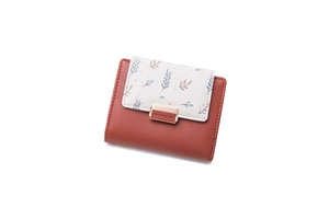 Detail of PU leather folding wallet with floral print and gold snap closure