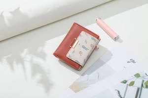 Short PU leather wallet featuring leaf pattern, snap button closure and brick red finish