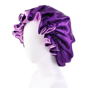 Detail of double-layered satin bonnet with ruffled edges in purple and light violet