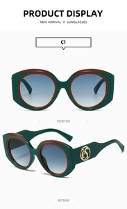 Detail view of retro wide-frame sunglasses with iconic red-green stripes and gold logo