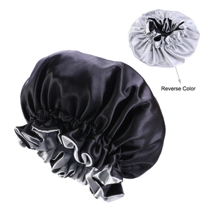 Close-up of double-layer satin sleep bonnet featuring a reversible black and silver design