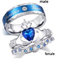 Detail of silver couple ring set with blue heart crystals and Forever Love engraving