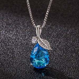 Elegant silver necklace with blue water drop pendant and diamond leaf design on black background