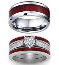 Detail of couple rings featuring red wood inlay and heart-shaped cubic zirconia stone