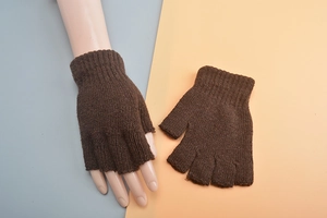Detailed knit texture of wool fingerless gloves in dark brown for winter warmth