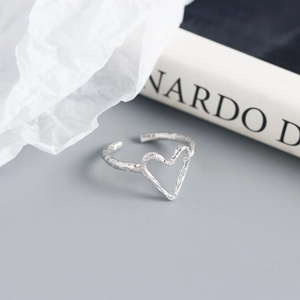Detailed macro view of S925 sterling silver heart ring with irregular foil texture