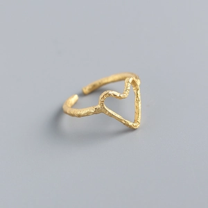 Detailed view of the golden heart-shaped ring with unique wrinkled texture finish