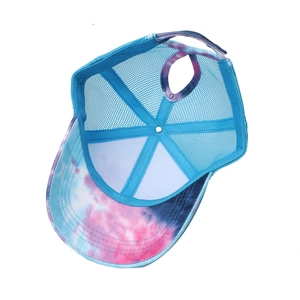Detail view of tie-dye baseball cap featuring breathable mesh and ponytail hole design
