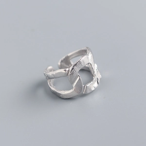 Macro shot of silver ring with irregular geometric foil texture and chain link design