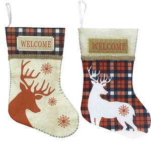Rustic Christmas stocking set with reindeer prints and Welcome text on plaid cuffs