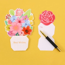 Floral greeting cards with bouquet and rose designs next to a premium pen on yellow base