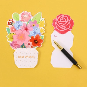 Detail of floral greeting cards with Best Wishes text and rose design on yellow background