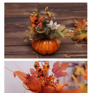 Detailed close-up of decorative foam pumpkin with sunflowers, berries and maple leaves