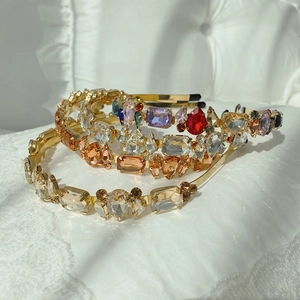 Detailed stack of Baroque style crystal headbands with vintage gold metal and large gemstones