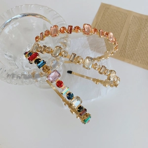 Macro shot of baroque style headband with multicolored rhinestones on a gold alloy frame