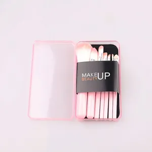 Macro detail of 7-piece pink makeup brush set in a compact transparent travel case