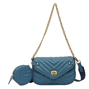 Dusty blue quilted leather crossbody bag with chain strap and matching coin purse