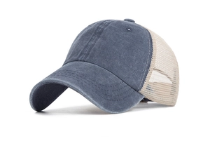 Detailed texture of grey-blue washed cotton and beige breathable mesh on the trucker hat