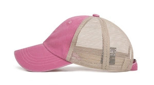 Detail of pink and beige trucker hat featuring breathable mesh back and cotton canvas front