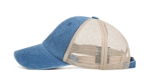 Side view of two-tone mesh trucker hat showing blue denim front and beige mesh back