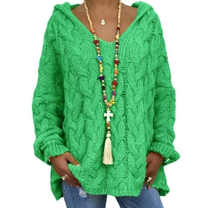 Close-up of bright green cable-knit hoodie with oversize fit and drawstring detail