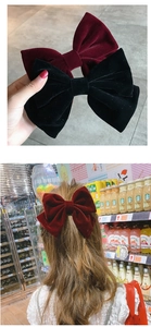 Detailed view of red and black velvet bow hair clips and hair accessory styling