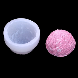 Macro detail of a spherical ice cream texture silicone mold with a pink wax craft sample