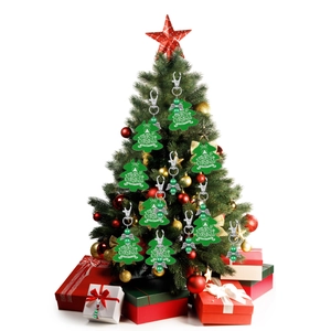 Detail of green metal Christmas tree ornaments with pearls and festive greeting text
