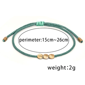 Handmade Tibetan green braided rope bracelet with golden irregular beads and adjustable strap