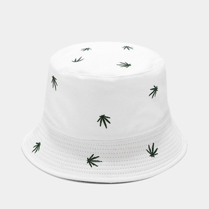Close-up of leaf embroidery texture and cotton fabric on a white bucket hat