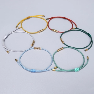 Detail of adjustable woven cord bracelets with irregular copper beads in six colors
