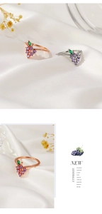 Detail view of grape rings in rose gold and silver with purple and green crystals
