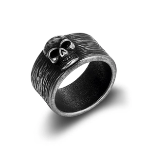 Macro shot of 3D skull relief on a vintage silver ring with oxidized punk metal texture