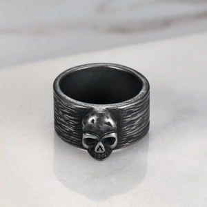 Macro shot of retro skull ring with aged silver finish and detailed brushed metal texture