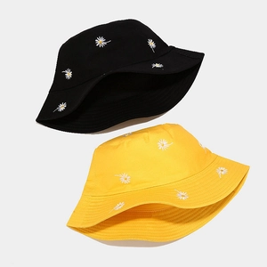 Dual view of black and yellow cotton bucket hats featuring white daisy embroidery detail