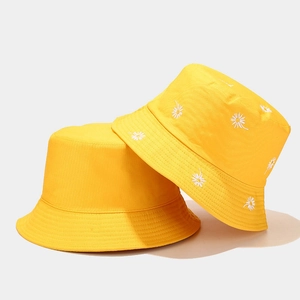 Double-sided reversible yellow bucket hat with daisy embroidery and minimalist plain design