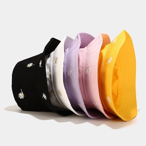 Daisy embroidered bucket hats in multiple colors including black, white, and yellow