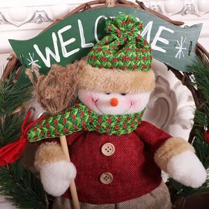 Nordic Christmas wreath with snowman figurine and welcome sign on rattan ring
