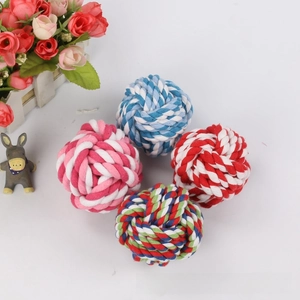 Detailed view of four colorful braided cotton rope balls for dog chewing and teeth cleaning